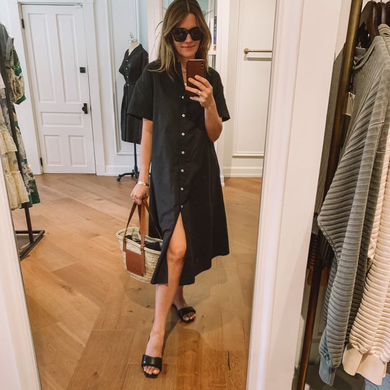 Social media shot of the yara oversized midi dress in black styled with black slides, oversized sunglasses and a summer tote..