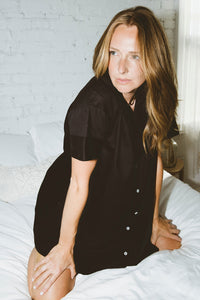 Editorial shot of the Amy crop collared button up mini dress in black.